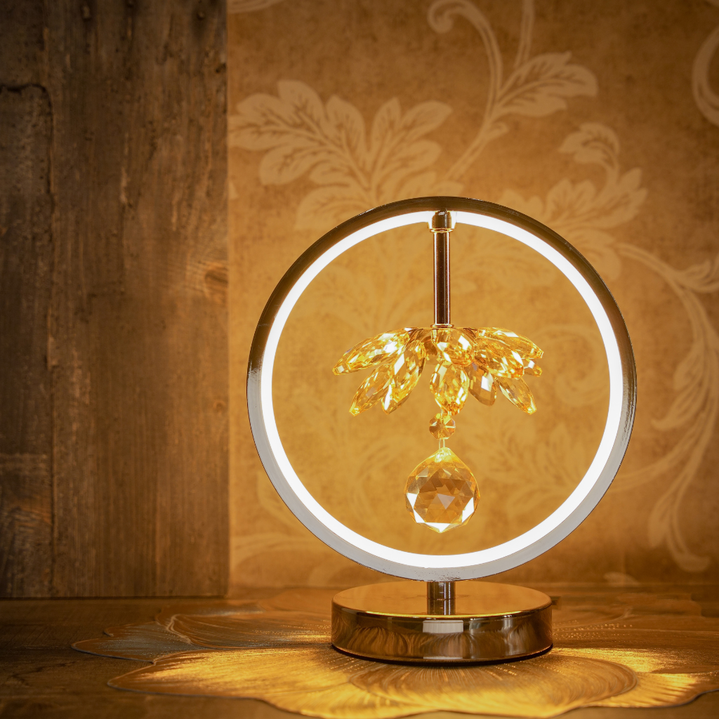 Decorative lamp with palm tree and crystal design on a wooden surface.