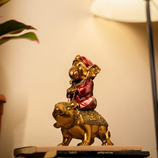 Decorative statue of Lord Ganesha on a gold animal with a blurred background