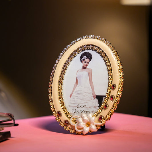 Decorative photo frame with a bride's portrait on a pink surface